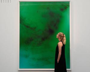 An employee poses next to 'Frieschwimmer 193' by Wolfgang Tillmans, at Sotheby's in London. Photo...