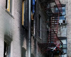 Windows of burned apartments are seen after a fire in a building in Bronx, New York. Photo: Reuters