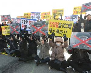 South Korean people attend a protest opposing Vice chairman of the North Korean ruling party's...