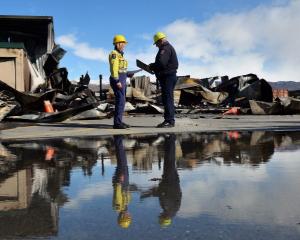 Fire risk management officers Catherine Trevathan and Stuart Ide confer at the scene of the...