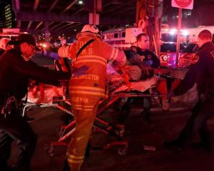 Paramedics and members of the FDNY perform CPR on a victim of a helicopter that crashed into the...