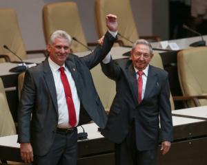 Newly elected Cuban President Miguel Diaz-Canel (L) reacts as former Cuban President Raul Castro...