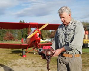 Before taking off in a Tiger Moth for a flyover of an Anzac Day service in Lowburn, Daniel...