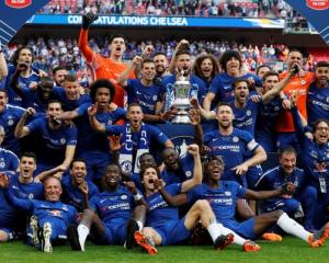 Chelsea celebrate winning the final with the trophy. Photo: Reuters