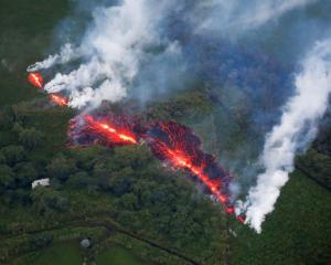 Lava erupts from a fissure east of the Leilani Estates subdivision during ongoing eruptions of...