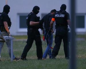 Twenty-year-old Iraqi Ali B. is escorted by special police upon his arrival in Wiesbaden. Photo:...