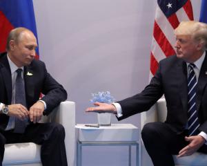 US President Donald Trump (right) meets with Russian President Vladimir Putin during their...