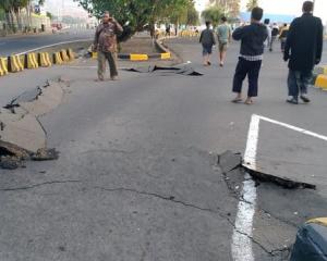 A crack emerges on a road at Kayangan Port after an earthquake hit Lombok. Photo: Bayu Wiguna via...
