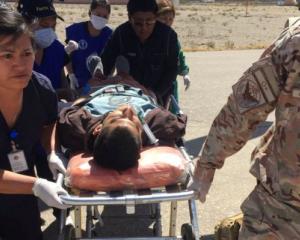 A person is transported to a helicopter after eating contaminated food at a funeral in the...