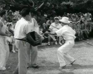 A still from the New Zealand National Film Unit clip, that shows Samuela Ariki, all in white,...