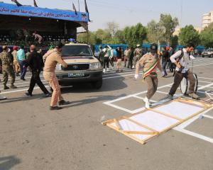 Iranian security forces take security measures after an armed attack targeting a military march...