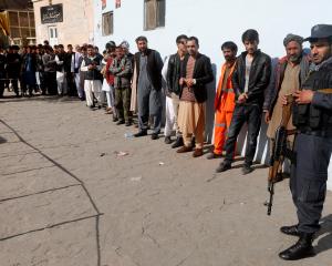 Afghan men line up to vote in Kabul, Afghanistan. Photo: Reuters