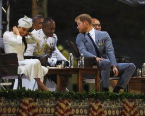 Britain’s Prince Harry and Meghan, the Duchess of Sussex attend an official welcome ceremony in...