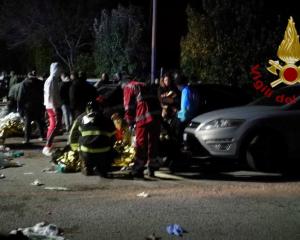 Emergency personnel attend to victims of a stampede at a nightclub in Corinaldo, near Ancona,...