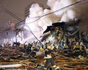 Firefighters operate at the site where a large explosion occurred at a restaurant in Sapporo....