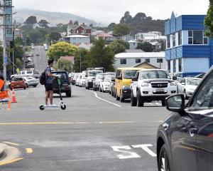 Traffic queues at the intersection of Clyde and Albany Sts yesterday, where a trial roundabout is...