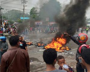 People burn tires during a protest at a road in Manokwari, West Papua, Indonesia. Photo: Reuters