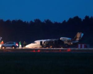 A private Cessna 560XL aircraft is seen after crashing while landing at Aarhus Airport in...