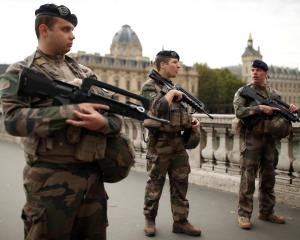 Security personnel is seen after an attack on the police headquarters in Paris. Photo: Reuters