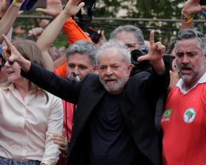 Former Brazilian President Luiz Inacio Lula da Silva arrives to deliver a speech after being...