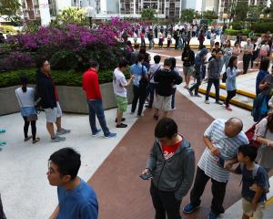 Voters queue to vote at a polling station during district council local elections in Hong Kong....
