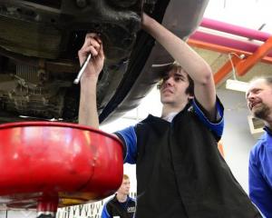 Otago Polytechnic automotive engineering student Issac Sonntag (18) works on an oil change, with...