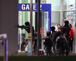 Thailand security forces enter in a shopping mall as they chase a shooter hidden in after a mass...