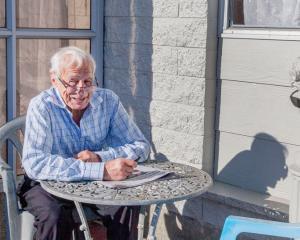 Enjoying the sun with a friend on Richill St, Belfast. "He doesn't talk much, and his jokes are...