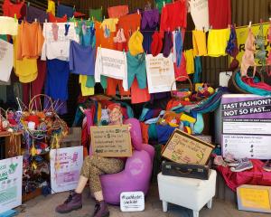 Kate Martin draws attention to the Six Items Challenge display at the front of Wastebusters in...