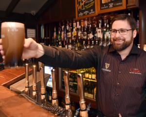 Bruce Hoffman, duty manager at Craic in the Octagon, pours a beer yesterday. PHOTO: PETER MCINTOSH