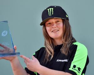 Champion motocross rider Courtney Duncan shows off the trophy presented to her for winning the...