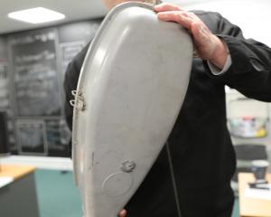 Waitaki District Council road safety co-ordinator Jason Evered holds a streetlight that was shot....