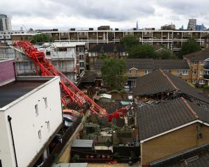 A collapsed crane is seen at a construction site in Bow, east London. Photo: Reuters