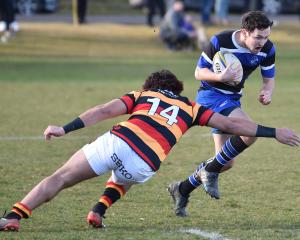 Kaikorai winger Jordan McEntee attempts to get past Zingari-Richmond opposite Willie Time at...