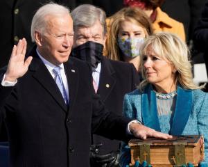 Joe Biden is sworn in as the 46th president of the United States as Jill Biden holds the Bible...