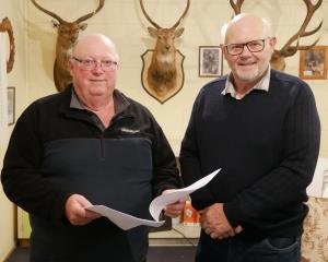  New Zealand Deerstalkers Association North Otago president David Hay (left) and hut project co...