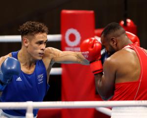 Youness Baalla (red) of Morocco defends as Kiwi Olympian David Nyika throws a punch. Photo: Getty...