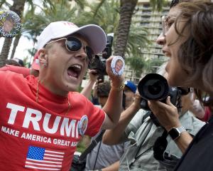 A Trump supporter and protestor engage in California. Photo: Getty Images 