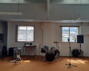 A practice room in Spaceland. Below, the inaugural gig. PHOTOS: SUPPLIED