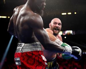 Tyson Fury (right) landed a flurry of punches in the 11th round, finally knocking out Deontay...