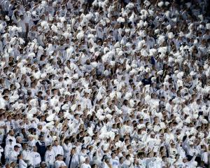 Members of the Penn State student section cheer their team against the Indiana Hoosiers in...