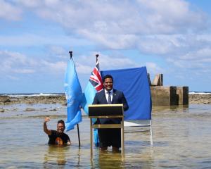 Tuvalu's Minister for Justice, Communication &amp; Foreign Affairs Simon Kofe gives a COP26...