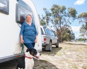 Anna Ferguson with dog Izzie at the Lowburn camping area. Figures released by Land Information...