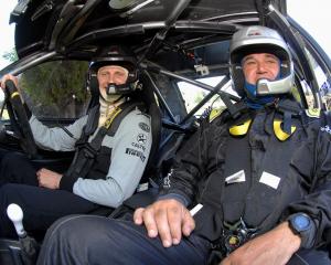 New Zealand rowing great Hamish Bond (left) and co-driver Grant Marra go for a drive in...