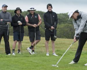 Parker Aluesi tees off at Chisholm Links Golf Club in Dunedin, in front of team mates (from left)...
