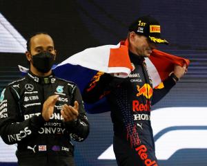 Red Bull's Max Verstappen celebrates winning the race and the world championship with the...