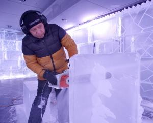 Sculptor Victor Cagayat cuts through a block of ice at Queenstown Ice Bar this week. PHOTO: GUY...