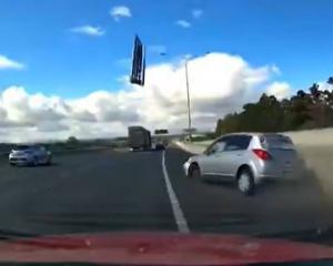 This is the frightening moment a car lost control and went slamming into the road barrier on SH1....