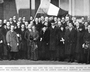 Members of the Irish republican party Sinn Fein, headed by Eamon de Valera, pose after walking...