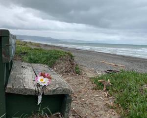 Flowers have been left at Leithfield Beach where human remains have been found. Photo: Kurt Bayer...